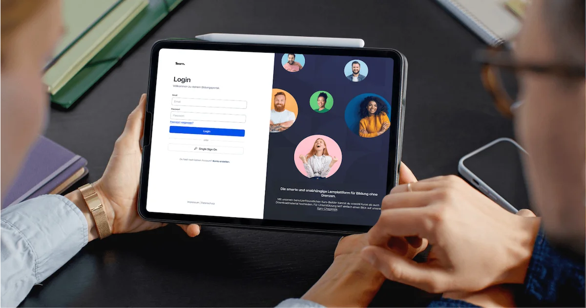 Zwei Personen betrachten auf einem Tablet die Login-Seite der digitalen Lernplattform 1learn.